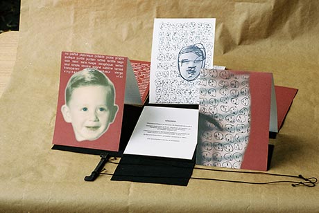Photograph of the artist as a child. Drawings depicting only tiny faces in black and white.