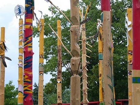 A circle, 30 feet in diameter, made up of 40 pine masts approximately 8 inches in diameter and 12 feet high, decorated and sculpted by 5 Aboriginal artists; Jacques N�washish, Christine Sioui Wawanoloath, �liane Kistabish, Virginia P�s�map�o-Bordeleau et Gilles Dorais, to commemorate the 300th anniversary of the 1701 Great Peace of Montreal, in 2001.