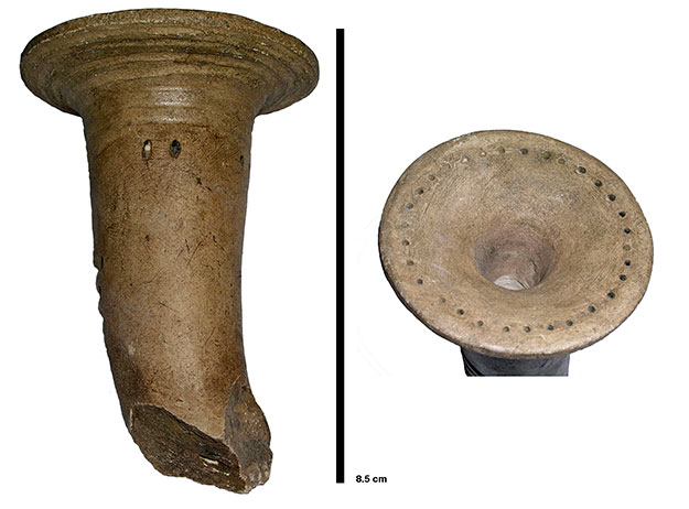 Trumpet pipe: This pipe's shape resembles a trumpet, whence its name. It is represented by two images: the oblong bowl is cracked at its heel. It is smooth and its top part is funnel-shaped. The other image shows the rim of the pipe head, which is rather flattened, as is the tobacco chamber. It is decorated with small, carved holes arranged in a circle around the rim.