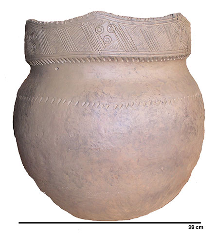Ceramic vase very similar to the one in image 3, but more oval at its base. It has four points rather than five on its neck and the small circles are arranged in a triangle.